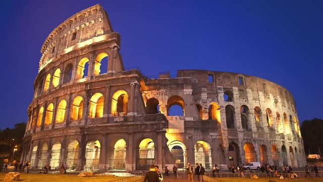 Illuminated Time-lapse of the Roman Colosseum at night with a full moon Rome, Italy