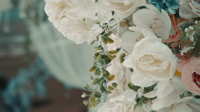 Closeup view of beautiful bouquet of flowers for wedding celebration is in light interior indoors.