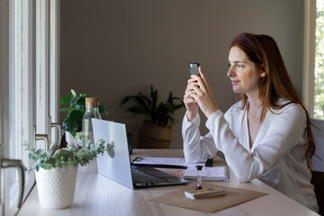 Psychologist using mobile phone while sitting at home