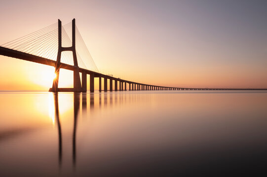 Portugal, Lisbon District, Lisbon, Vasco da Gama Bridge at sunset