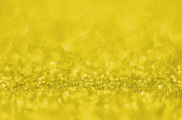 Illuminating Pantone Color Of The Year 2021. Abstract festive bokeh background with shining defocus sparkles. Blurred glitters shimmering dust macro close up, copy space for text logo