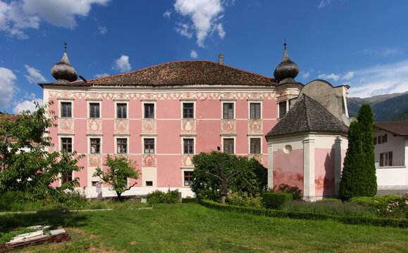 Pink baroque Mühlrain manor in the historical village of Latsch in Vinschgau region, South Tyrol in Italy