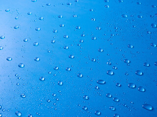Random water drops on the blue PVC surface