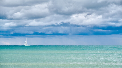 Single Sailboat close to Venice, with calm sea before the storm