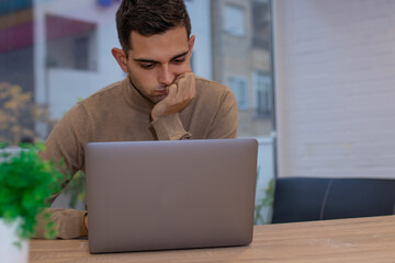 man at home working with laptop