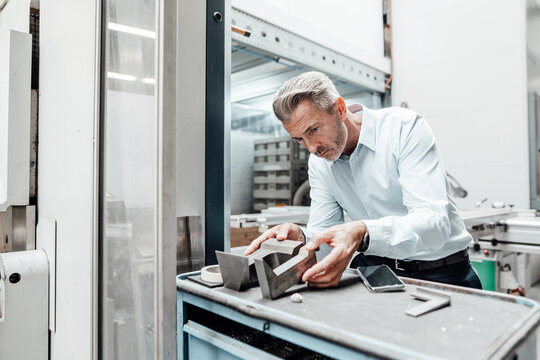 Male engineer examining equipment in industry