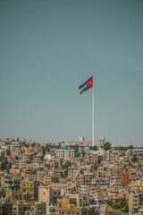 Amman City, Jordan view at summer with a big national flag 