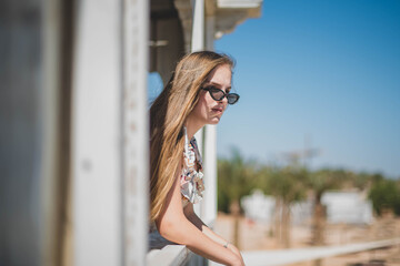 girl in cafe on the beach. young slim beautiful woman on sunset beach, playful, dancing, running, bohemian outfit, indie style, summer vacation, sunny, having fun, positive mood, romantic