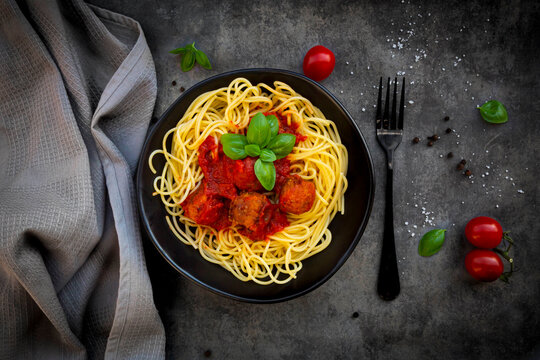 Bowl of spaghetti with vegetarian polpette and basil