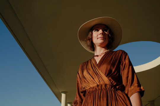 Mid adult woman wearing hat standing in resort at Deauville, France