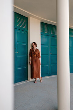 Tourist leaning on wall by door in resort at Deauville, France