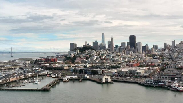 San Francisco, USA. Aerial footage of modern architecture in the downtown. Skyscrapers and docks with Bay bridge in the background. High quality 4k footage