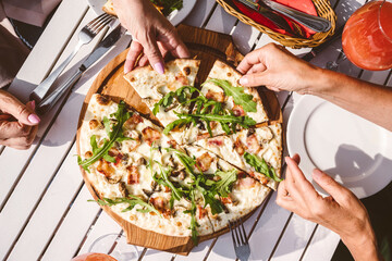 Mature female friends having pizza at restaurant