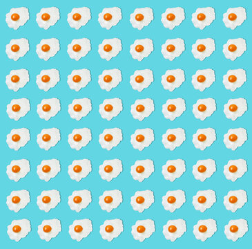 Pattern of fried eggs against blue background