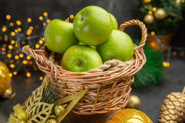 front view fresh green apples around christmas toys on dark background color photo xmas holiday...