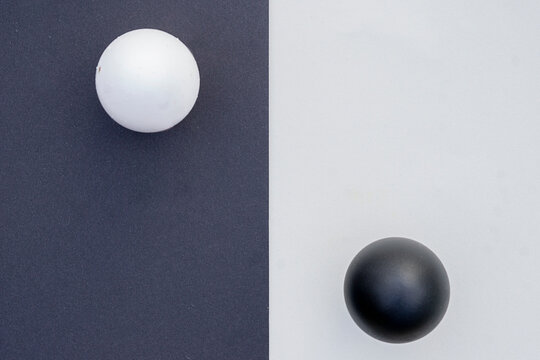 Studio shot of black and white eggs on contrasting backgrounds