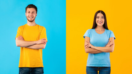 Smiling confident couple posing with folded arms on studio background