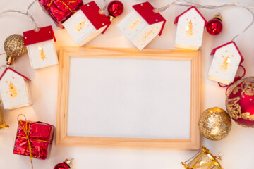 Christmas wooden frame mocap. Christmas balls, garlands, red and gold decorations on a white background. Flat lay, top view, copy space.
