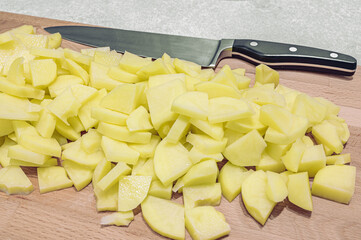 Vegan food preparation. chopped potatoes on a cutting board with a close-up.