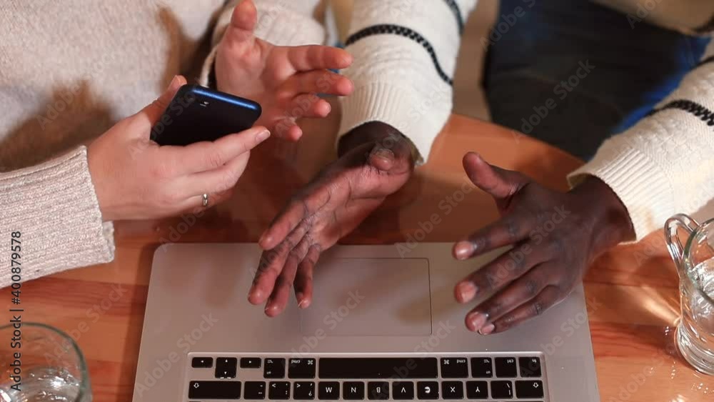 Poster hands of afro and white team workers use the phone with laptop on the table. gesturing people during