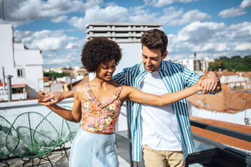 Interracial couple learning dance movement together