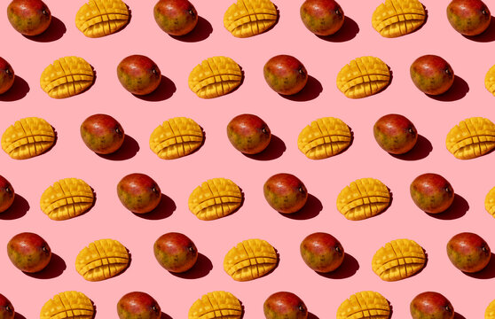 Whole and chopped mango pattern on pink background
