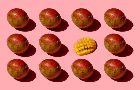 Whole and one chopped mango pattern on pink background