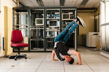 Young man performing stunt on floor in abandoned room