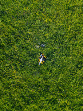 Woman lying on grass, aerial view