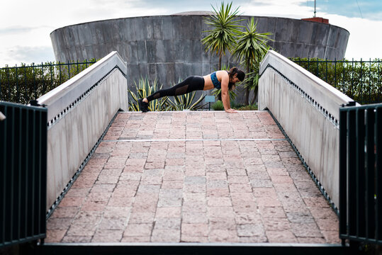 Young woman during workout on bridge