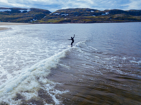 Russia, Murmansk region,&not;&dagger;Kolsky&not;&dagger;District, Teriberka, Surfer on Barents Sea waves, aerial view