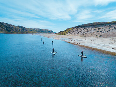 Russia, Murmansk Oblast,&not;&dagger;Kolsky&not;&dagger;District, Teriberka, Sup surfers on&not;&dagger;Teriberka&not;&dagger;river, aerial view