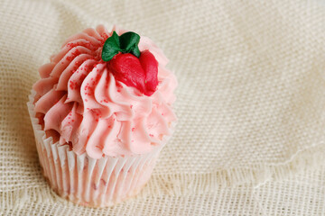 Pink decorative icing on cupcake for sweet dessert food.