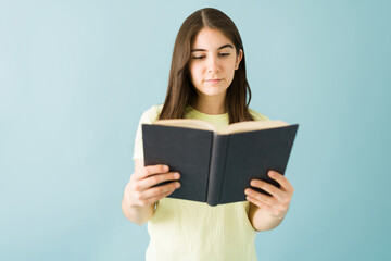 Good-looking woman concentrated on reading a book