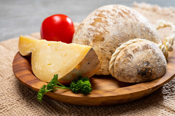 Italian semi hard matured caciocavallo cheese, handmade and aged in natural underground caves in Apulia region