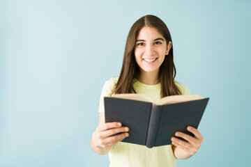 Portrait of a woman looking happy to be reading a book
