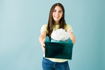 Smiling caucasian woman is giving a present to someone