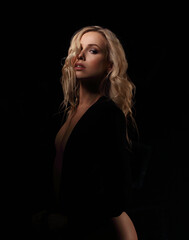 Naklejka premium Beautiful hot saxy makeup woman with in black shirt, nude chest on dark black background with empty copy space. Closeup portrait. Art.