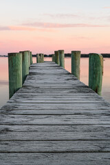 Fototapeta premium Winter sunrise over a frost covered dock