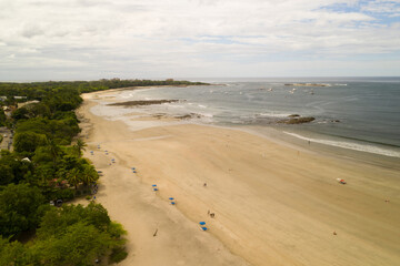 A aerial view of the beach in Tamarindo Costa Rica taken from a drone.