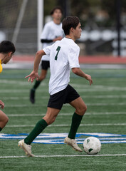 Athletic young boy playing in a competitive soccer game