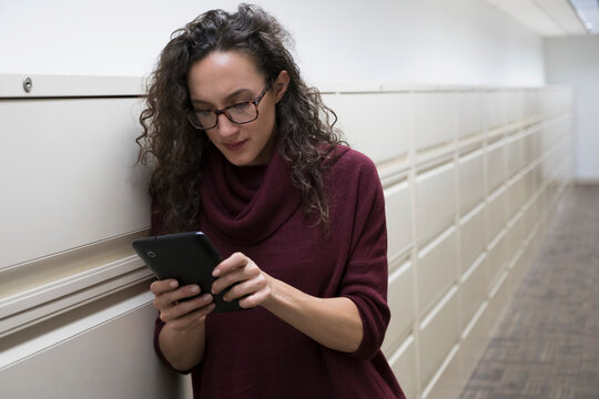 Young woman using digital tablet in corridor