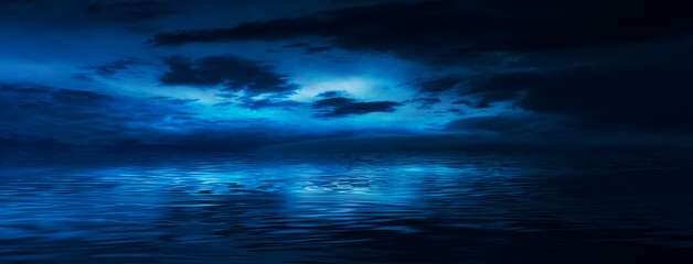 Night sky, horizon at sunset, moonlight, clouds, waves reflected in water. Empty sea landscape, natural scene. Night view.