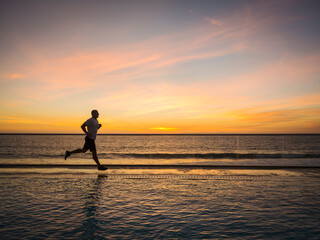 Man jogging along poolside