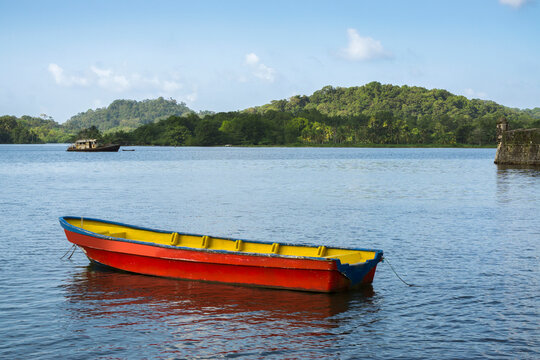 Boat on bay with green hills in background