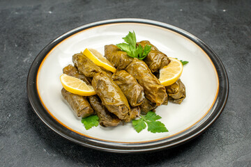 bottom view stuffed grape leaves on white plate traditional azerbaijani dish dolma on dark background with free space