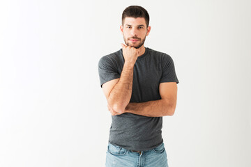 Good-looking young guy is in a deep thinking position