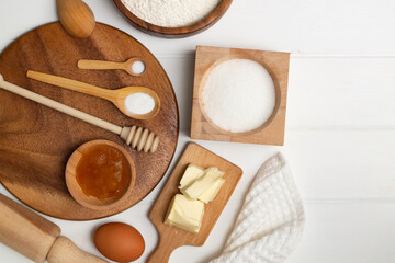 Bakery ingredients: butter, flour, sugar, egg, honey, soda, salt. Flat lay. Copy space