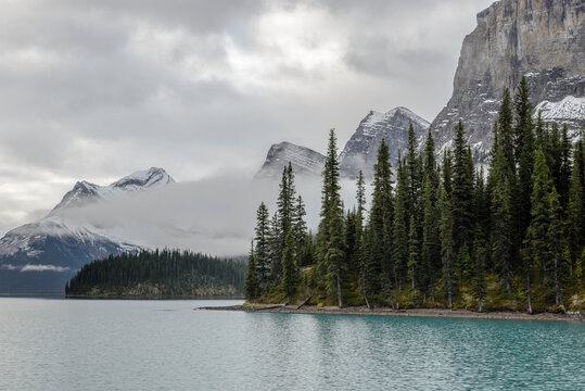 Canada, Alberta, Jasper, Clouds above mountains and Maligne Lake