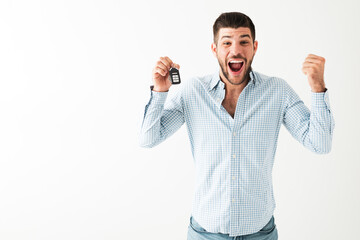 Young man just received the keys of his brand new car